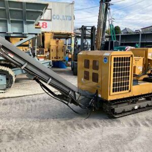 Morooka MC-300D self-propelled wood chipper with horizontal feed hopper and discharge conveyor extended, on rubber crawler tracks, parked outdoors.